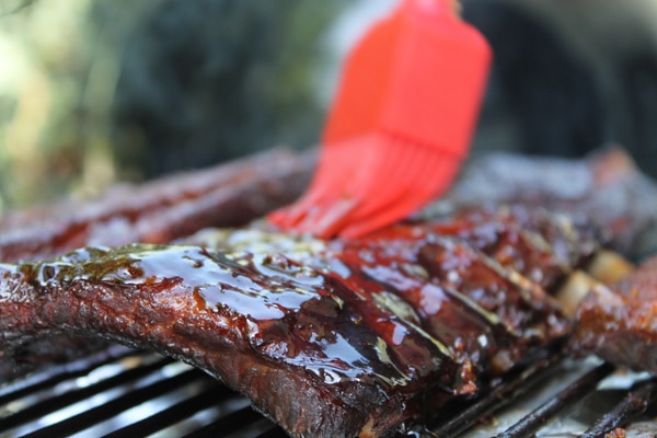 Close-up of barbecue ribs on a grill, glazed with sauce, perfect for a Fripp Island vacation rental cookout.