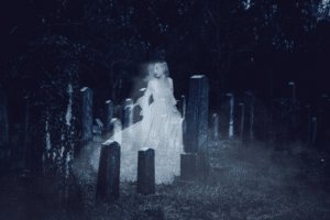 Ghostly woman in white dress appears among old gravestones on a foggy Fripp Island night.