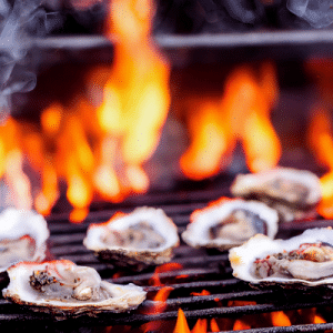 Oysters cooking on a grill with bright orange flames and smoke, capturing the flavors of a Lowcountry beach vacation.