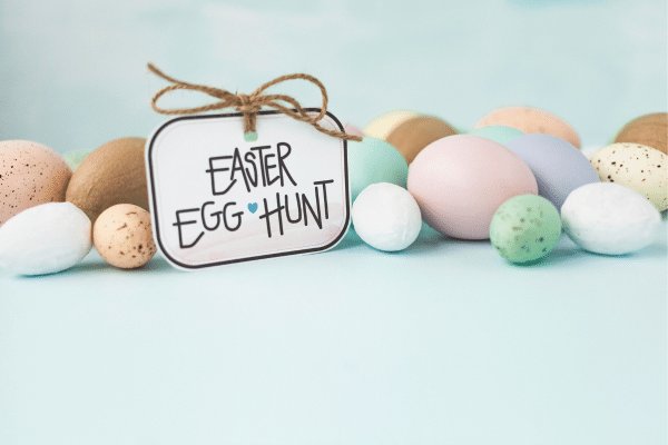 Pastel and speckled Easter eggs with a tag that reads Easter Egg Hunt on a light blue, lowcountry-inspired background.