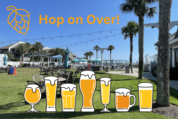 Outdoor patio with tables, palm trees, and beer glasses—perfect for a Fripp Island vacation rental.