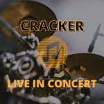 Drum set and microphones with text: CRACKER LIVE IN CONCERT overlaid in bold yellow letters.