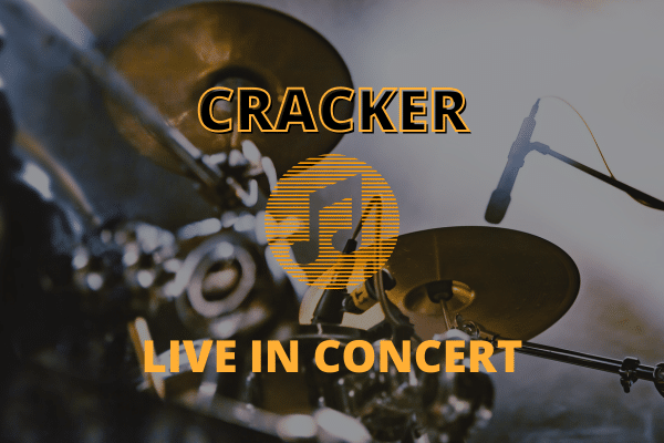 Drum set and microphones with text: CRACKER LIVE IN CONCERT overlaid in bold yellow letters.