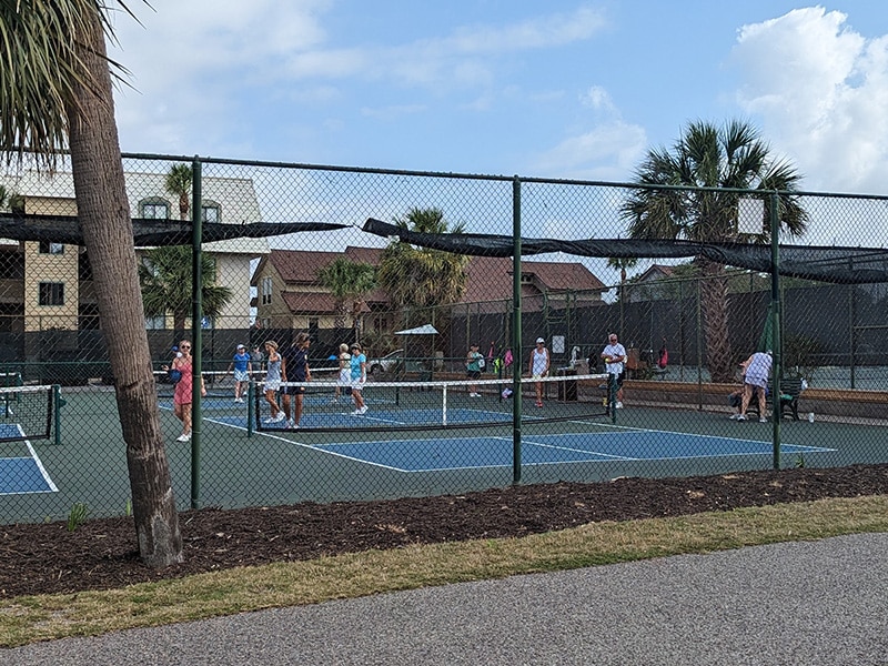 People play pickleball on outdoor courts at the Fripp Island Racquet Club.