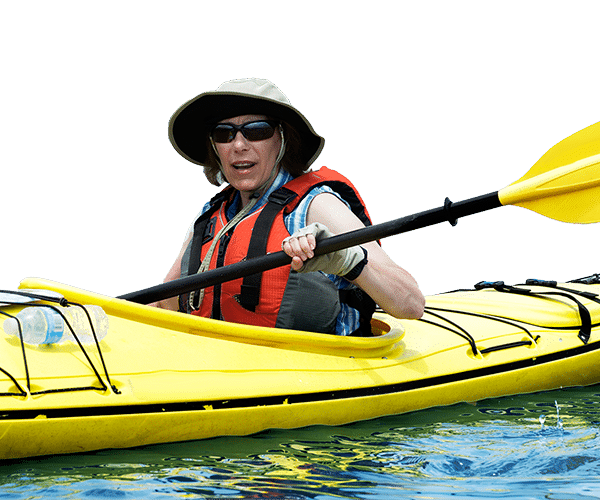 Person in hat and life jacket paddling a yellow kayak on water with an oar.